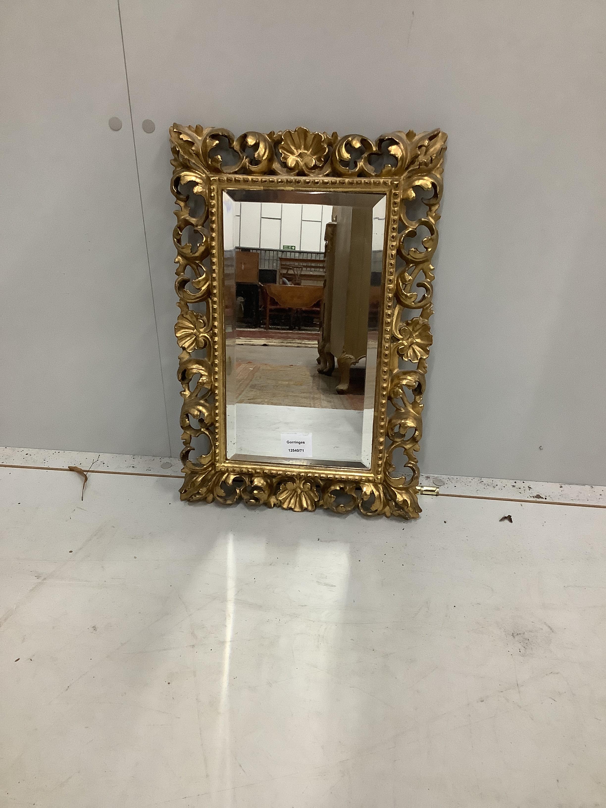 A small Florentine rectangular carved giltwood wall mirror, width 32cm, height 47cm